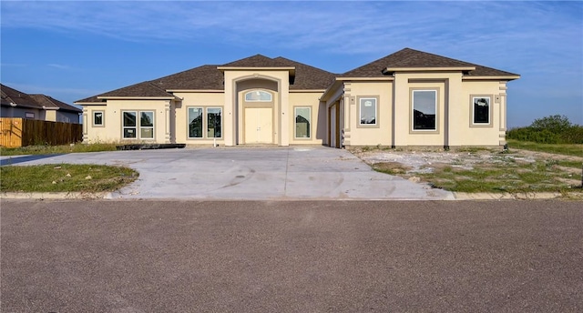 4033 Ranch Lake Dr, Corpus Christi, TX 78413 - view of front of home featuring stucco siding and a shingled roof