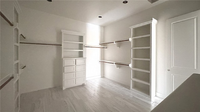 spacious closet featuring light hardwood / wood-style floors