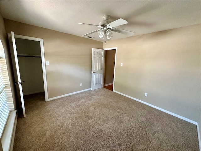 6313 Ramsgate Cir, Corpus Christi, TX 78414 - unfurnished bedroom with carpet, baseboards, a closet, a walk in closet, and a ceiling fan