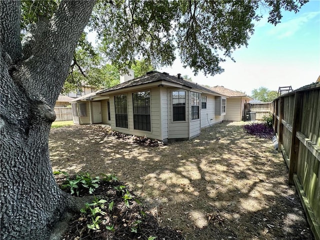 6313 Ramsgate Cir, Corpus Christi, TX 78414 - rear view of house with a fenced backyard, a chimney, and central air condition unit