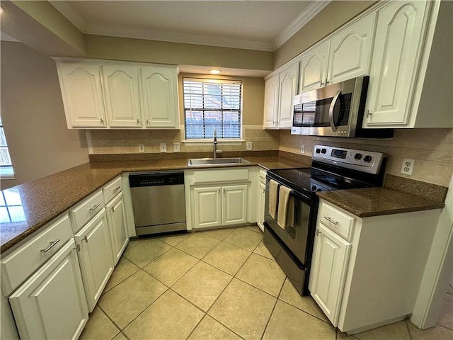 6313 Ramsgate Cir, Corpus Christi, TX 78414 - kitchen with stainless steel appliances, a sink, crown molding, white cabinetry, and light tile patterned flooring