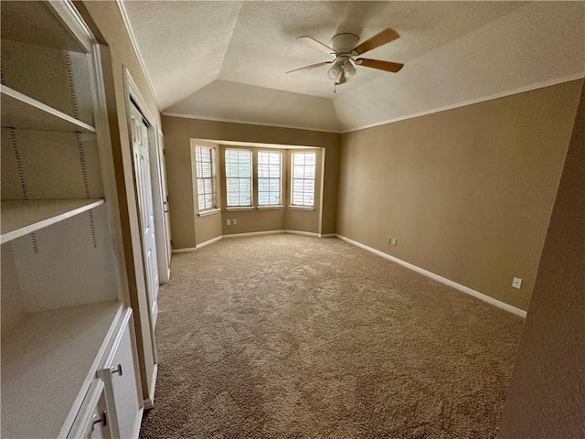 6313 Ramsgate Cir, Corpus Christi, TX 78414 - carpeted empty room with vaulted ceiling, a ceiling fan, baseboards, a textured ceiling, and crown molding