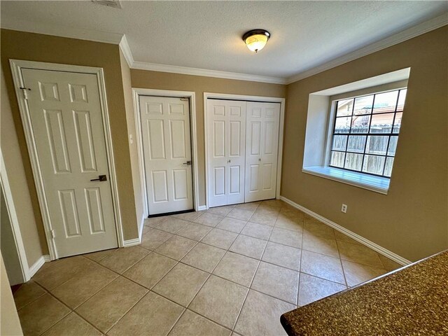 6313 Ramsgate Cir, Corpus Christi, TX 78414 - unfurnished bedroom with light tile patterned floors, crown molding, baseboards, and a textured ceiling