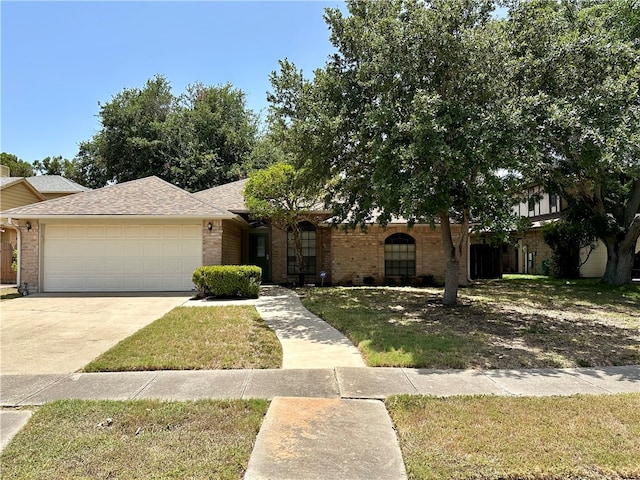 view of front of home with a garage and a front lawn