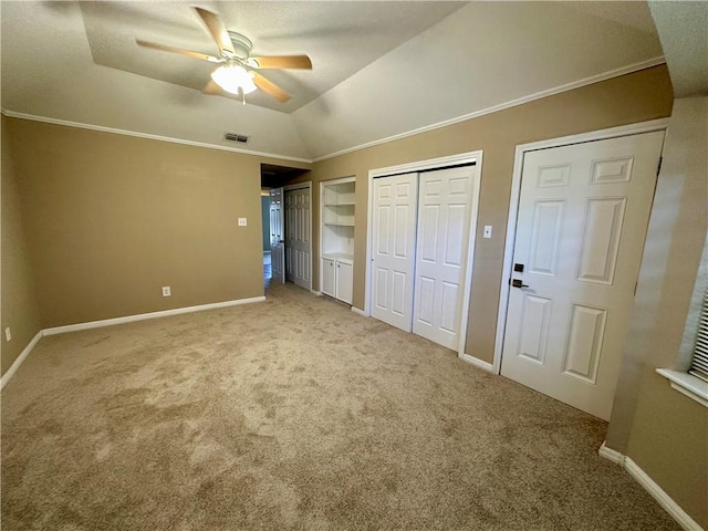 6313 Ramsgate Cir, Corpus Christi, TX 78414 - unfurnished bedroom featuring carpet, multiple closets, baseboards, ornamental molding, and lofted ceiling