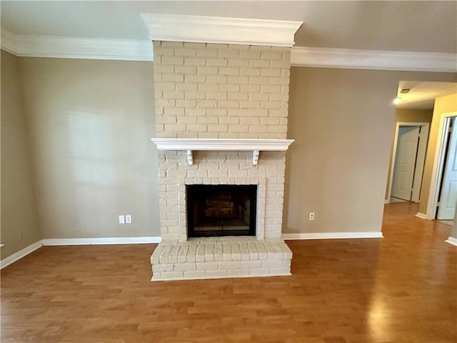 6313 Ramsgate Cir, Corpus Christi, TX 78414 - detailed view of crown molding, wood finished floors, baseboards, and a brick fireplace