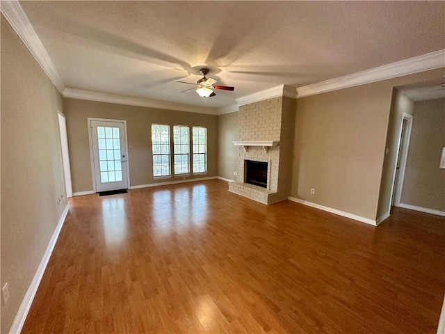 6313 Ramsgate Cir, Corpus Christi, TX 78414 - unfurnished living room with a ceiling fan, wood finished floors, baseboards, a fireplace, and crown molding