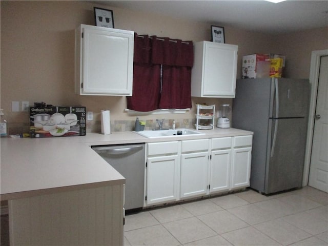 kitchen featuring kitchen peninsula, stainless steel appliances, light tile patterned floors, white cabinets, and sink