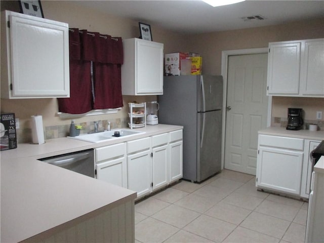 kitchen with sink, white cabinets, and appliances with stainless steel finishes