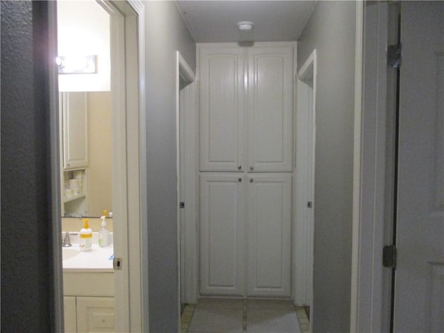 hall featuring light tile patterned floors