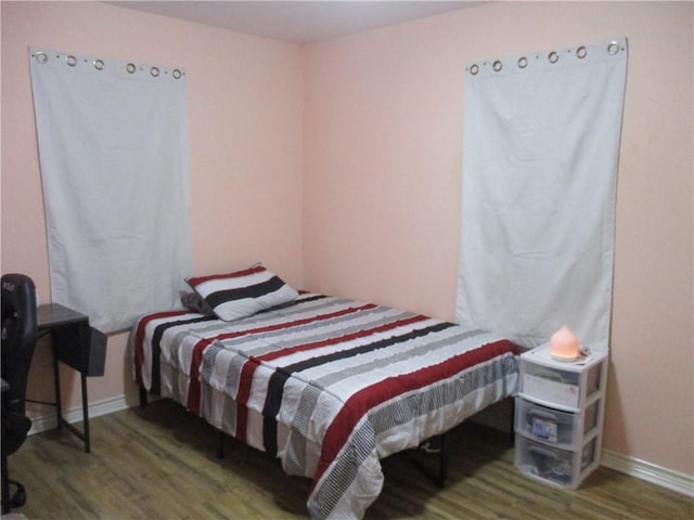 bedroom with wood-type flooring