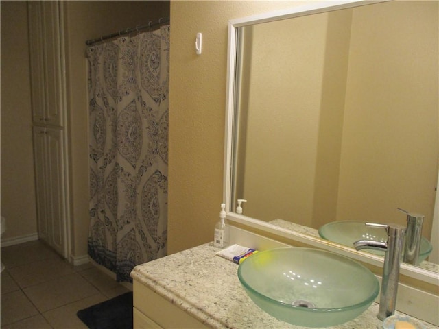 bathroom featuring tile patterned flooring, vanity, and a shower with curtain