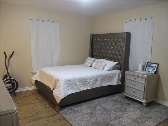 bedroom with dark hardwood / wood-style floors