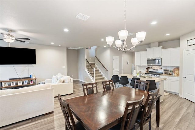 7221 Tristan Dr, Corpus Christi, TX 78414 - dining space featuring light wood-style floors, recessed lighting, stairs, a chandelier, and ceiling fan