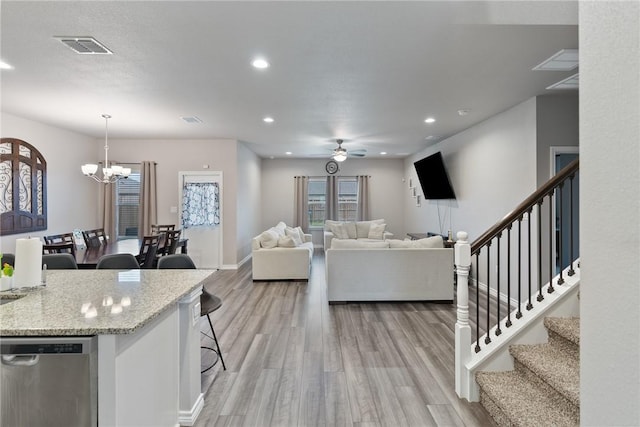 7221 Tristan Dr, Corpus Christi, TX 78414 - living room featuring light wood-style flooring, a chandelier, ceiling fan, stairway, and recessed lighting