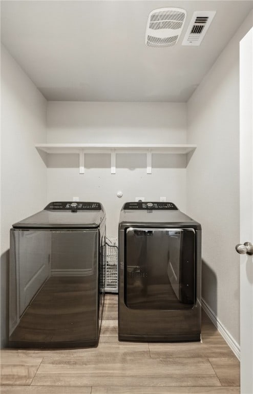 1293 Carnaby St, Corpus Christi, TX 78415 - laundry area with washing machine and clothes dryer and light wood-style floors