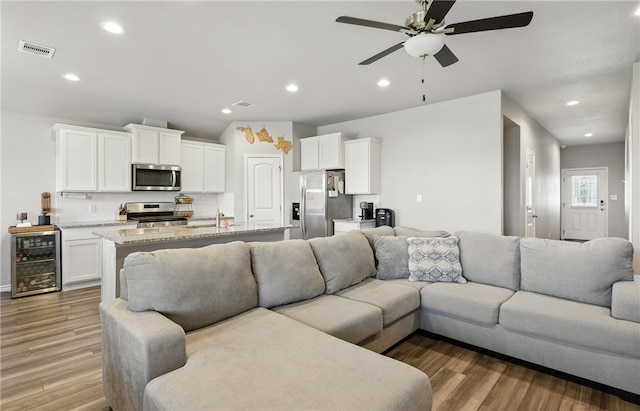1293 Carnaby St, Corpus Christi, TX 78415 - living area with wine cooler, ceiling fan, light wood-type flooring, and recessed lighting