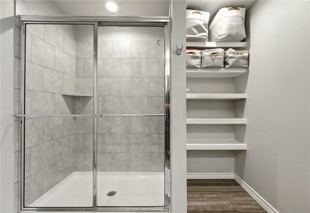 1293 Carnaby St, Corpus Christi, TX 78415 - bathroom featuring a shower stall and wood finished floors