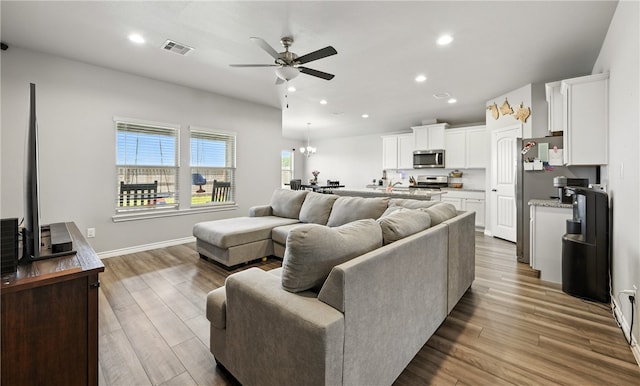 1293 Carnaby St, Corpus Christi, TX 78415 - living area with ceiling fan, wood finished floors, recessed lighting, and a chandelier