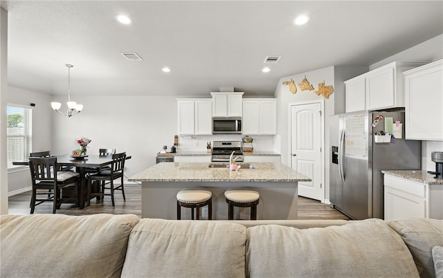 1293 Carnaby St, Corpus Christi, TX 78415 - kitchen with appliances with stainless steel finishes, open floor plan, white cabinets, dark wood-style flooring, and recessed lighting