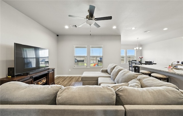1293 Carnaby St, Corpus Christi, TX 78415 - living room with wood finished floors, recessed lighting, ceiling fan, and a chandelier
