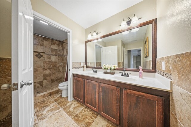 5413 King Trl, Corpus Christi, TX 78414 - bathroom featuring tile walls, double vanity, a tile shower, and toilet