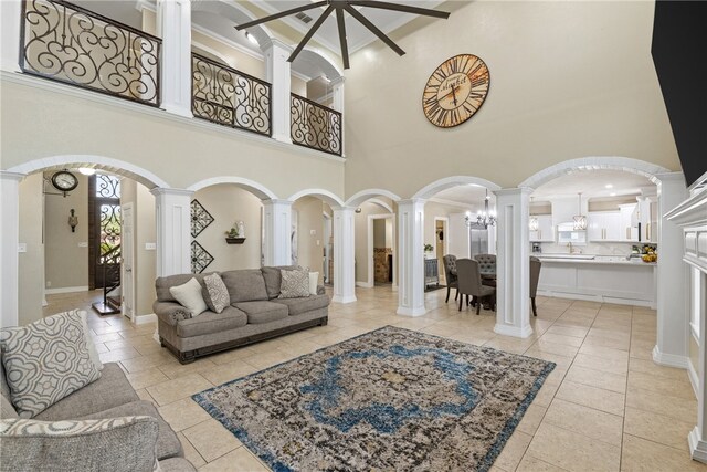5413 King Trl, Corpus Christi, TX 78414 - living room with decorative columns, ornamental molding, a high ceiling, baseboards, and light tile patterned floors