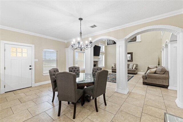 5413 King Trl, Corpus Christi, TX 78414 - dining area featuring arched walkways, decorative columns, light tile patterned floors, ornamental molding, and a chandelier