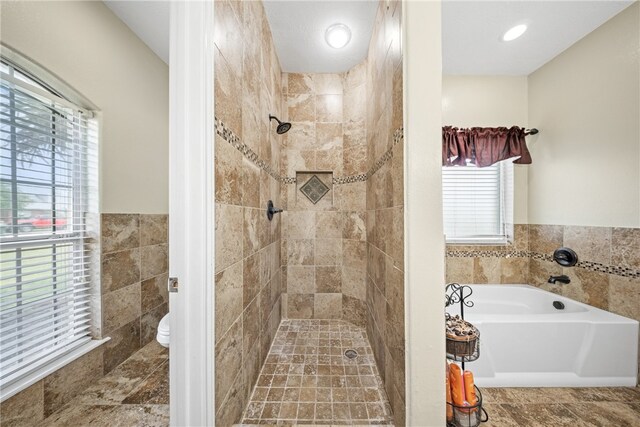 5413 King Trl, Corpus Christi, TX 78414 - bathroom with a garden tub, a tile shower, toilet, and tile walls