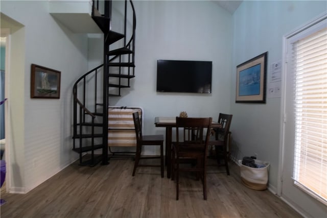 dining room with wood-type flooring and a healthy amount of sunlight