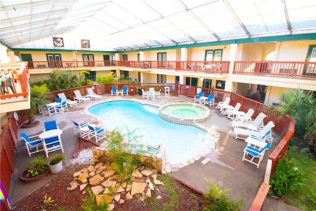 view of pool featuring a hot tub and a patio area