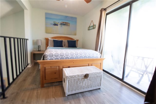 bedroom with lofted ceiling, ceiling fan, dark hardwood / wood-style flooring, and access to outside