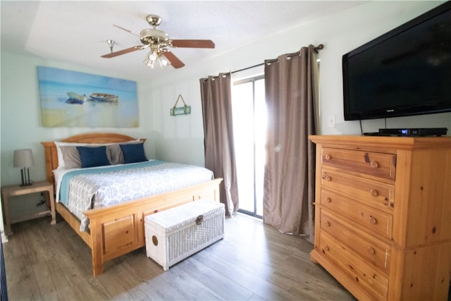 bedroom with wood-type flooring and ceiling fan