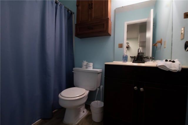 bathroom featuring hardwood / wood-style floors, vanity, and toilet