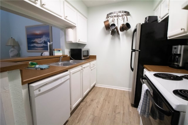 kitchen featuring light hardwood / wood-style floors, white cabinetry, sink, wooden counters, and white appliances