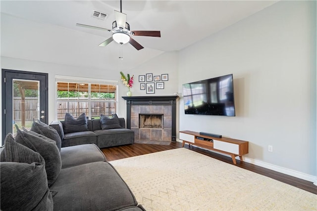 4230 Rapids Dr, Corpus Christi, TX 78410 - living room with vaulted ceiling, wood finished floors, a tiled fireplace, a ceiling fan, and baseboards