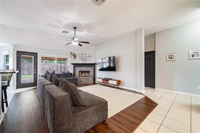 4230 Rapids Dr, Corpus Christi, TX 78410 - tiled living area with a ceiling fan, a fireplace, baseboards, and vaulted ceiling