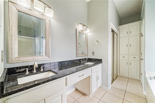 4230 Rapids Dr, Corpus Christi, TX 78410 - full bath with double vanity, tile patterned flooring, a bath, a shower with door, and baseboards