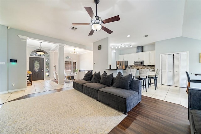 4230 Rapids Dr, Corpus Christi, TX 78410 - living area featuring light tile patterned floors, ceiling fan, ornate columns, baseboards, and a chandelier