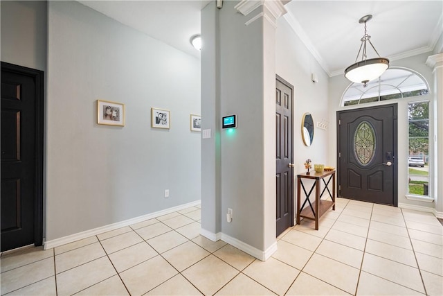 4230 Rapids Dr, Corpus Christi, TX 78410 - entrance foyer featuring decorative columns, ornamental molding, light tile patterned floors, and baseboards