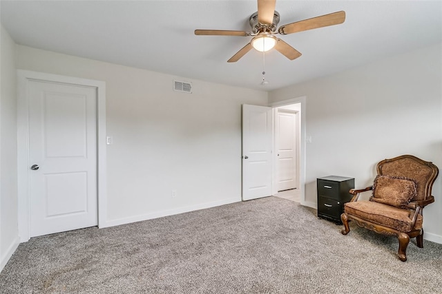 sitting room featuring visible vents, ceiling fan, light carpet, and baseboards