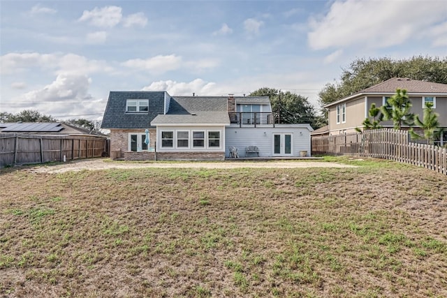 back of property with a patio, french doors, a lawn, and a fenced backyard