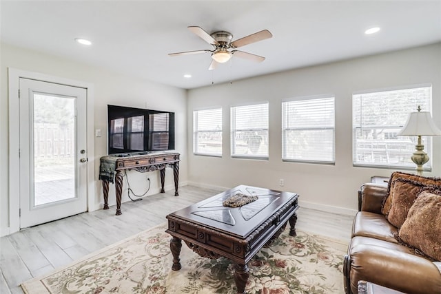 living area featuring recessed lighting, baseboards, ceiling fan, and light wood finished floors