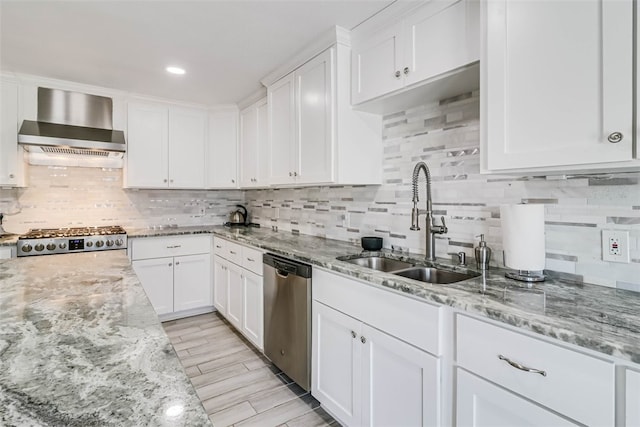 kitchen featuring white cabinetry, dishwasher, wall chimney exhaust hood, and stove