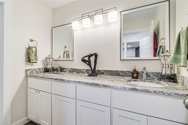 bathroom with a sink and double vanity