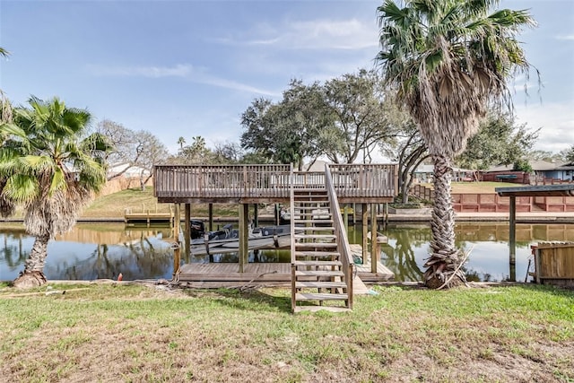 view of dock featuring a water view, boat lift, and a yard