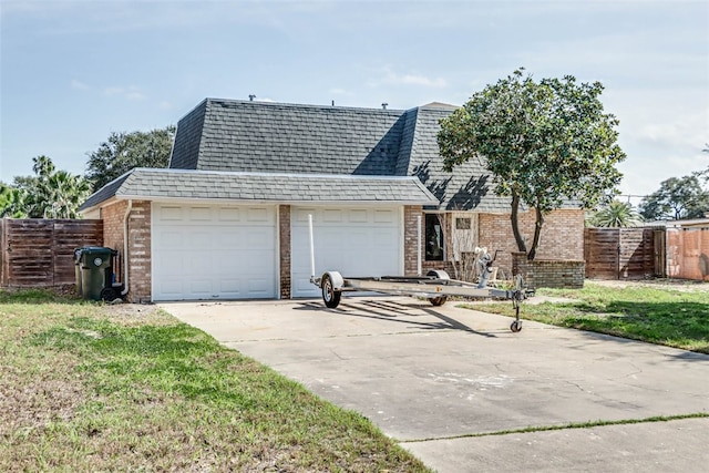 view of front of property with a shingled roof, fence, concrete driveway, and brick siding