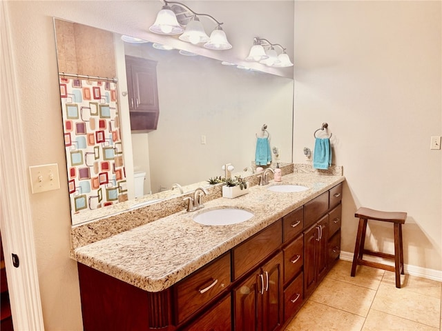 bathroom featuring tile patterned flooring, vanity, and toilet