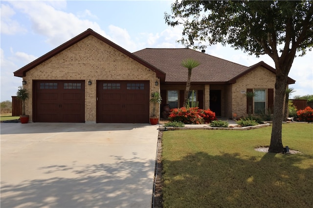 view of front of house with a garage and a front lawn