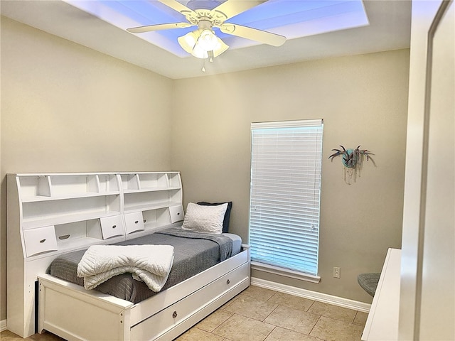 tiled bedroom featuring ceiling fan